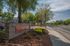 Welcoming entrance to Sandpiper Village, set amidst lush greenery and open skies, showcasing a serene residential community.