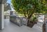 Charming apartment with serene patio views of lush greenery, featuring a modern community setting with abundant natural light.