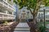 Charming apartment entrance surrounded by lush greenery and inviting walkways.