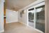 Inviting dining area with tiled floors, ceiling fan, and a view of the refreshing pool through sliding glass doors.