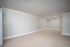 Bright and spacious room with plush carpet and elegant crown molding, featuring a modern ceiling fan to enhance comfort.