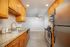 Modern kitchen with sleek stainless steel appliances, elegant granite countertops, and warm wooden cabinetry.