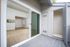 Modern apartment with open living area, plush carpet, and stylish sliding doors opening to a private balcony.