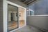 Cozy apartment patio with sleek sliding door leading to an inviting interior, featuring elegant wood flooring and modern design.
