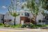 Charming Breakwater apartment complex exterior with modern architecture, lush landscaping, and a serene neighborhood vibe.