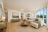 Bright, modern living room with elegant decor and large windows offering abundant natural light.