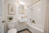 Elegant bathroom with a modern sink, stylish lighting, and cozy decor elements.