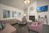 Inviting living room with plush seating, modern decor, cozy fireplace, and large windows offering natural light.