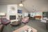 Inviting living space with modern decor, featuring cozy seating, a chic fireplace, and a stylish dining area with natural light.