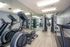 Modern fitness center with state-of-the-art gym equipment, mirrored walls, and sleek wooden flooring.