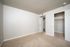 Bright and spacious empty bedroom with plush carpet, neutral walls, and a built-in closet, ideal for customization and comfort.