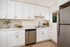 Modern kitchen with sleek stainless steel appliances, elegant white cabinetry, and a stylish marble countertop.