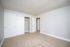 Bright and spacious bedroom with plush carpet, ample closet space, and neutral tones for a cozy and inviting ambiance.