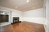 Kitchen with white cabinets, dark countertops, a double sink, and stainless steel refrigerator, range, and microwave.