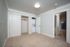 Spacious bedroom with plush carpet, large closet, and in-unit laundry for modern convenience.