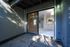 Inviting entrance with sliding glass door leading to a modern kitchen featuring sleek cabinetry and ample natural light.