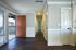 Inviting apartment entryway with elegant hardwood floors, abundant natural light, and stylish wainscoting, leading to a cozy hallway.