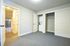 Bright and spacious bedroom with a built-in laundry area and ample closet space, highlighted by modern doors and carpet flooring.