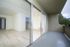 Inviting apartment with a spacious balcony, large sliding glass doors, and bright interior featuring sleek flooring and modern finishes.