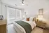 Bright and inviting bedroom with modern decor, featuring a cozy bed and stylish nightstands.