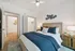 Modern and inviting bedroom with plush bedding, elegant decor, and a spacious closet.