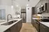 Modern kitchen with sleek stainless steel appliances, elegant dark wood cabinetry, and bright open lighting.