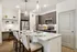 Modern kitchen with sleek stainless steel appliances, elegant pendant lighting, and a stylish breakfast bar with comfortable seating.