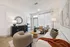 Elegant living room with cozy seating, stylish decor, and abundant natural light.