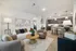 Elegant modern living room with plush seating, chic decor, and open-plan kitchen, perfect for stylish living and entertaining.