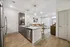 Modern apartment interior featuring an elegant kitchen island, sleek cabinetry, and open-concept living space with stylish decor.