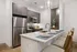 Modern kitchen with sleek appliances, stylish dark cabinetry, and a chic breakfast bar with elegant seating.