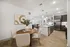Elegant open-concept apartment kitchen and dining area with modern stainless steel appliances and stylish decor.