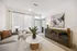 Chic and modern living room with a cozy gray sofa, elegant marble coffee table, and stylish decor, offering a warm and inviting atmosphere.
