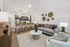 Stylish open-concept living space with modern kitchen, elegant decor, and cozy seating area.