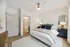 Inviting bedroom featuring elegant decor, plush bedding, and an en-suite bathroom with chic furnishings.