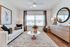 Bright and inviting living room featuring elegant d&eacute;cor, plush seating, and large windows enhancing natural light.