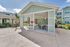 Charming outdoor pavilion with modern grilling area and stylish seating, perfect for entertaining in a serene apartment community.