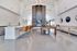 Elegant recreational lounge with modern open kitchen, stylish bar seating, and luxurious pool table.