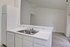 Bright, modern kitchen featuring sleek countertops, dual sink, and ample cabinetry in open-concept layout.