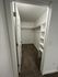 Spacious walk-in closet with modern shelving and ample storage space, perfect for organization and style.