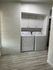 Chic laundry nook with modern washer and dryer set against a stylish white brick accent wall, offering convenience and elegance.