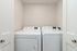Modern laundry area equipped with sleek washer and dryer set, offering convenience and efficiency in a compact space.