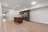 Modern kitchen with sleek stainless steel appliances, elegant wood cabinetry, and a spacious island perfect for entertaining.