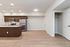 Modern open-concept kitchen with sleek cabinetry, stainless steel appliances, and elegant hardwood flooring, perfect for contemporary living.