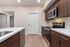 Modern kitchen with sleek wood cabinetry, stainless steel appliances, and elegant countertops for a stylish cooking experience.
