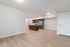 Spacious open-plan apartment featuring modern kitchen with stainless steel appliances and sleek hardwood floors.