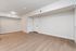 Modern apartment interior with elegant wooden floors, neutral-colored walls, and sleek white doors.