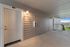 Charming apartment entry with elegant lighting on a covered walkway, offering scenic views of the surroundings.