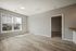 Bright and inviting living room with large windows and modern flooring.