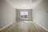 Bright room with elegant light wood flooring and large window offering natural illumination.